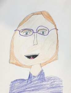 self-portrait of an elementary school girl with glasses and blonde hair wearing a blue shirt
